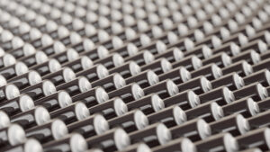ocean of layered blank black triple-A batteries presented with a shallow depth of field