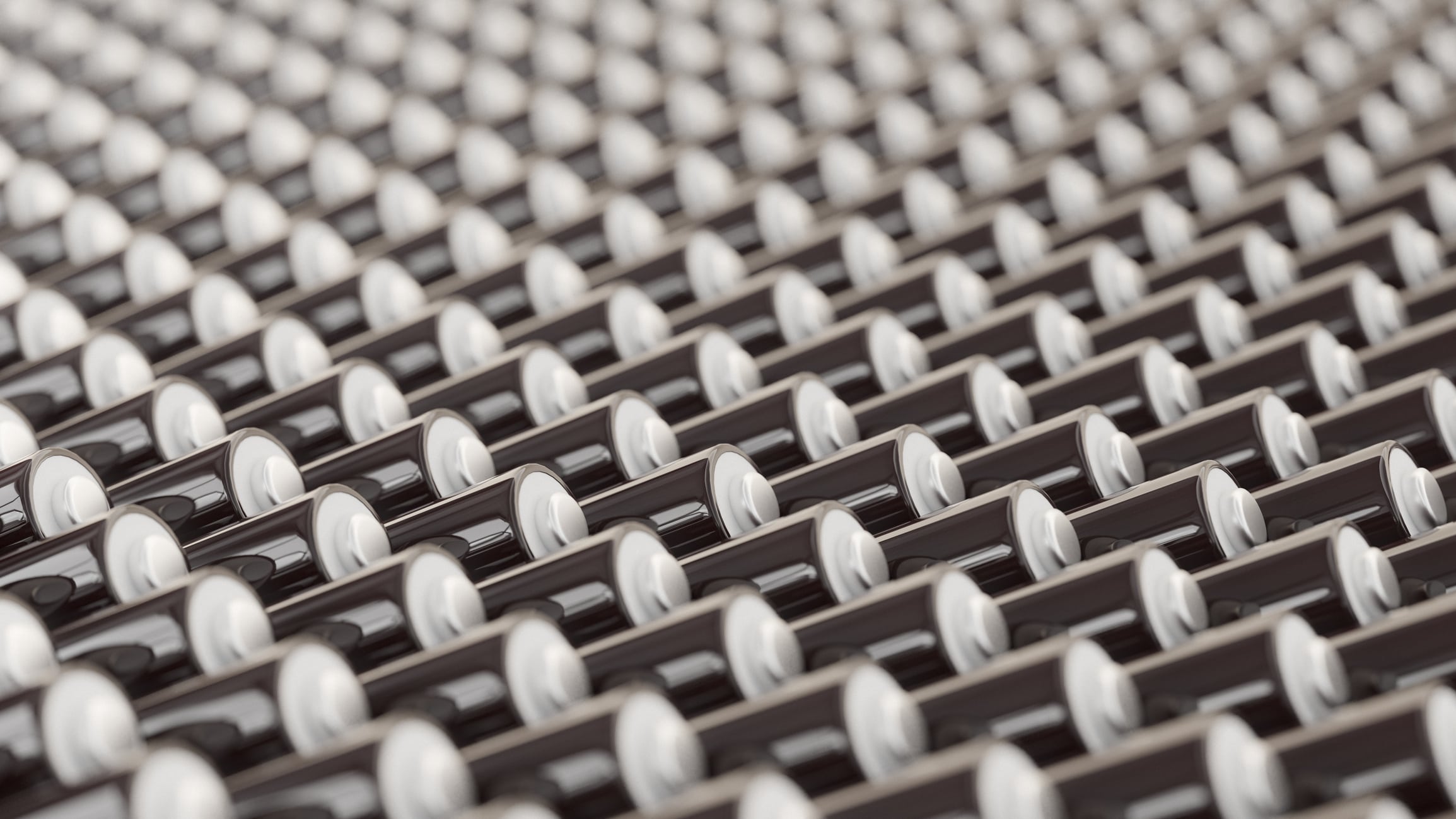 ocean of layered blank black triple-A batteries presented with a shallow depth of field