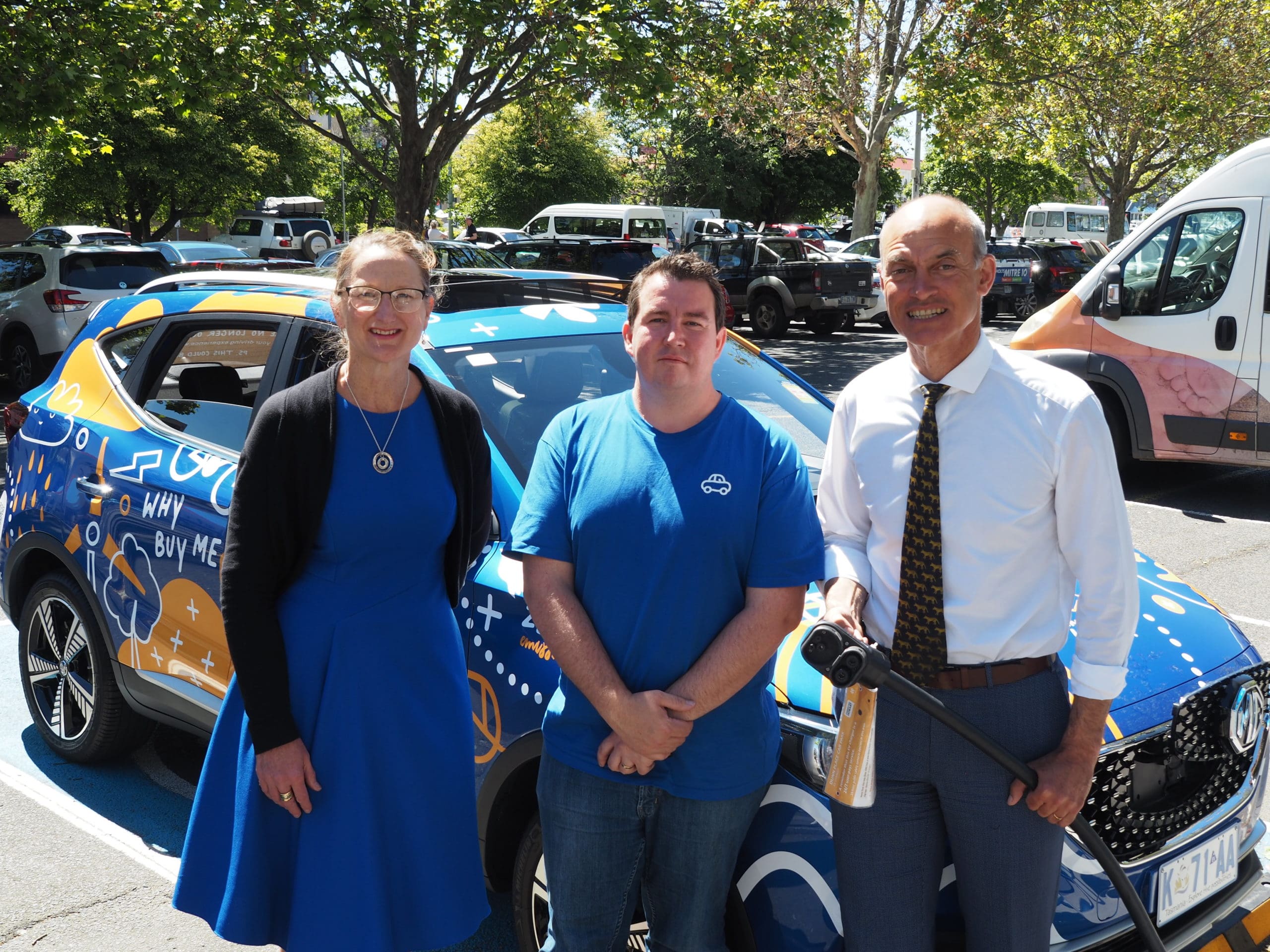 carbar employees standing in front of vehicle for aurora energy launch