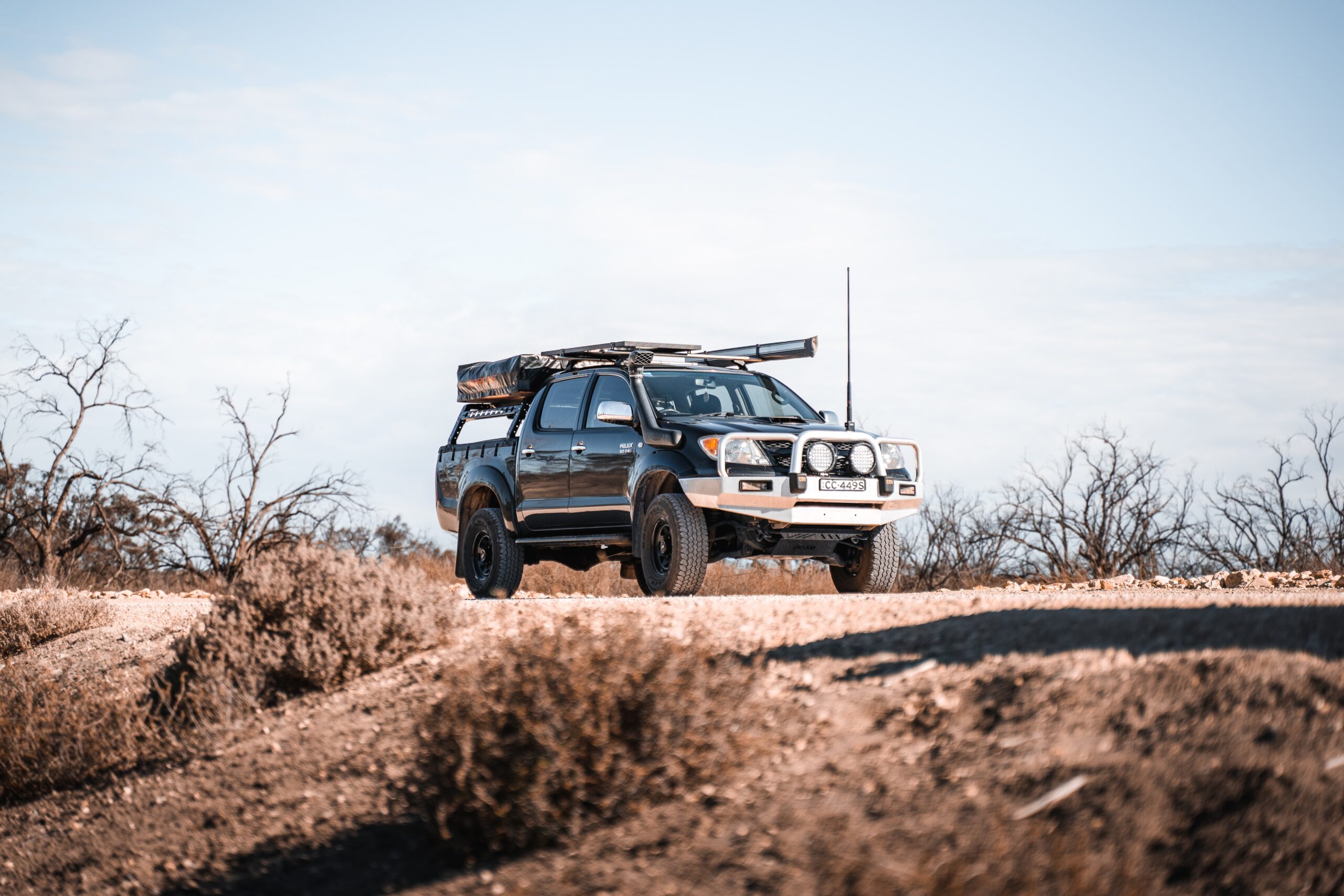 black toyota hilux ute with roof racks