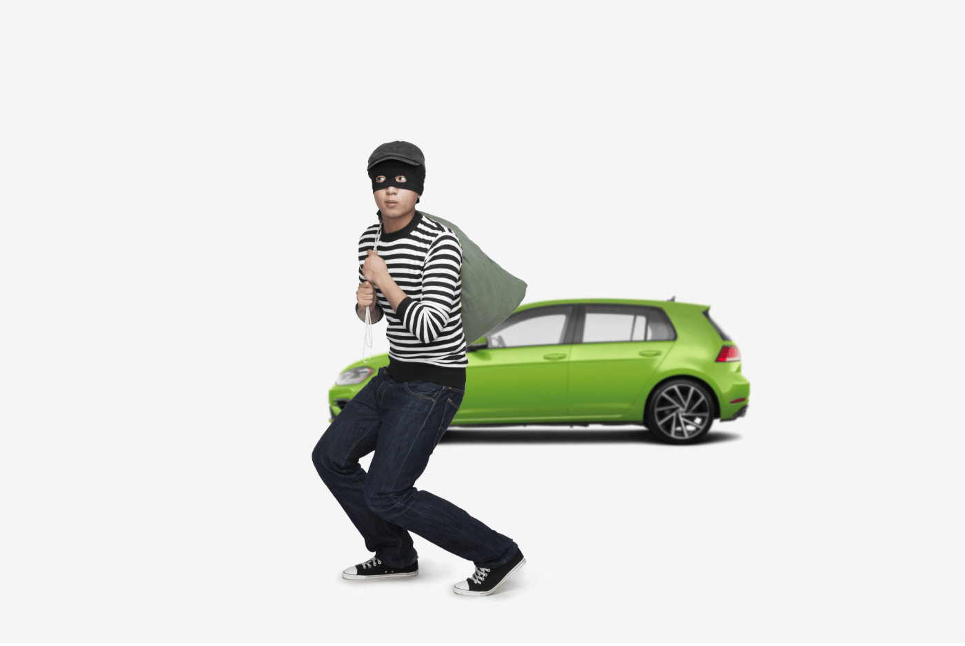 male burglar walking away from car after theft